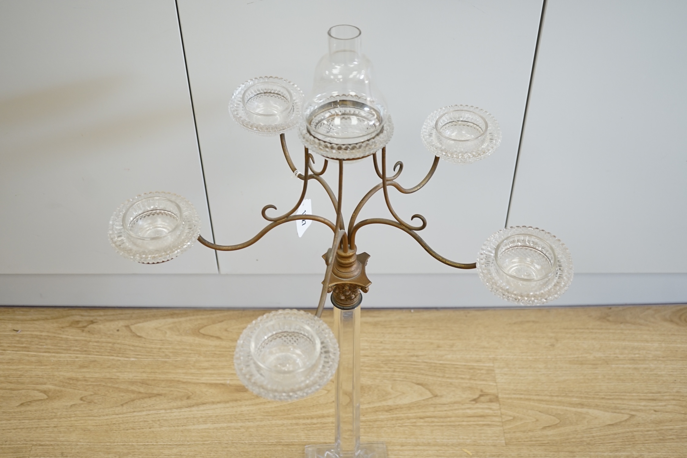 A Victorian glass and brass Corinthian column five branch, six light epergne centrepiece, 83.5cm high. Condition - slight chip to one corner of the base and funnel to top light chipped